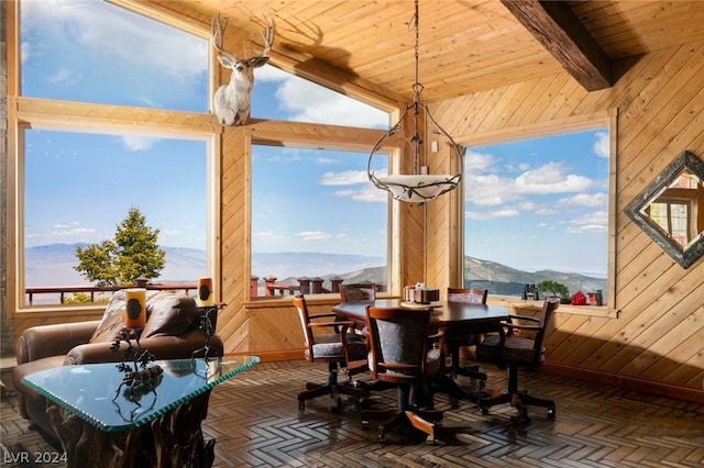 4910 Cougar Ridge Trl, Mount Charleston, NV 89124 - dining space with a mountain view, wooden walls, beamed ceiling, and wood ceiling