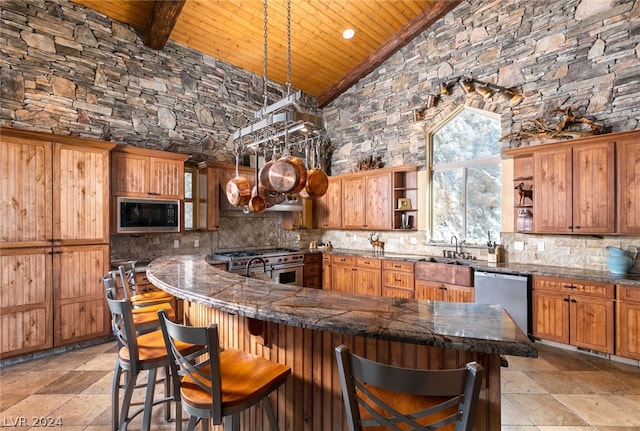 kitchen with appliances with stainless steel finishes, a breakfast bar area, pendant lighting, high vaulted ceiling, and wood ceiling