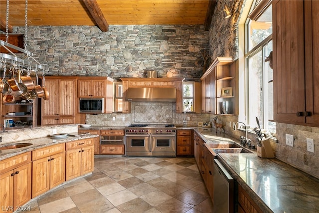 kitchen featuring tasteful backsplash, beam ceiling, wood ceiling, appliances with stainless steel finishes, and sink