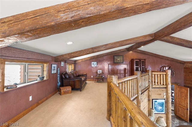 hallway with wooden walls, lofted ceiling with beams, and carpet flooring