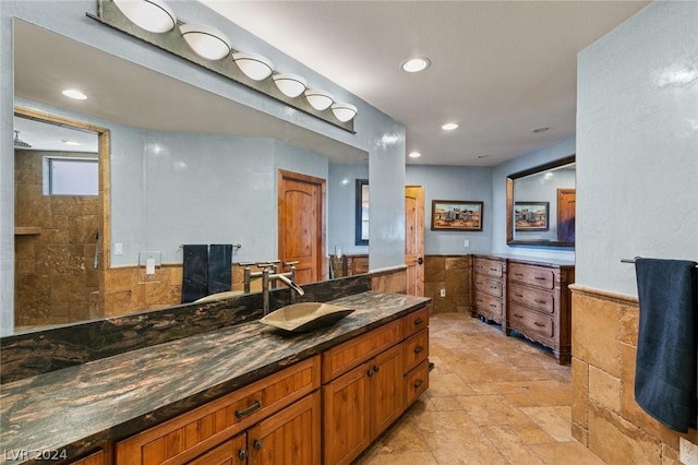 4910 Cougar Ridge Trl, Mount Charleston, NV 89124 - full bathroom featuring stone tile floors, a wainscoted wall, recessed lighting, vanity, and tile walls