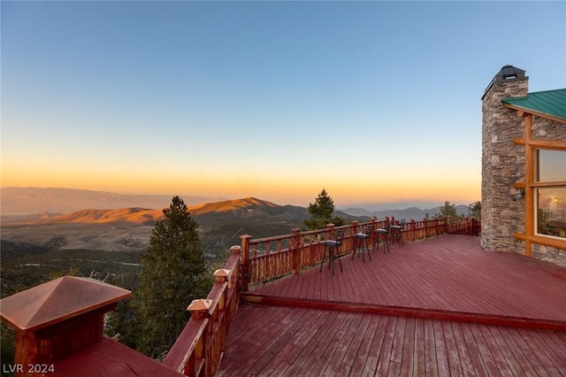 4910 Cougar Ridge Trl, Mount Charleston, NV 89124 - deck at dusk featuring a mountain view