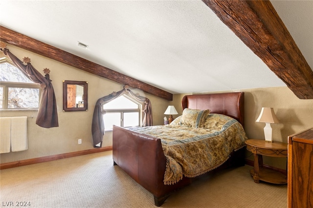 bedroom with a textured ceiling, carpet, and multiple windows