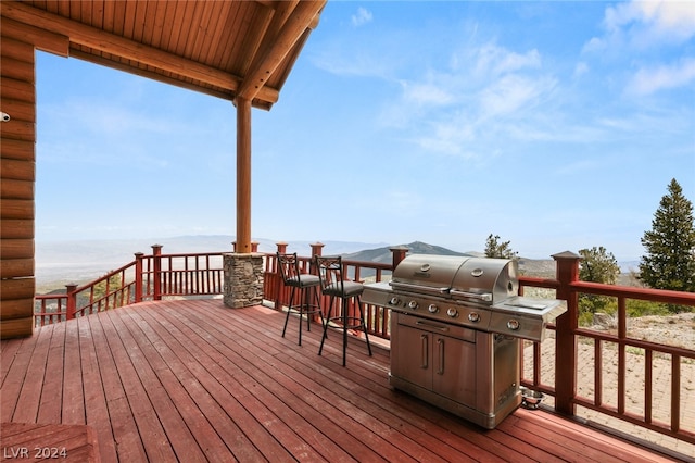 deck featuring grilling area and a water view