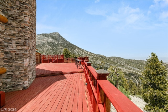 wooden deck with a mountain view