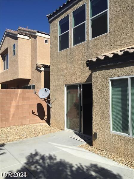 view of property exterior with a patio area