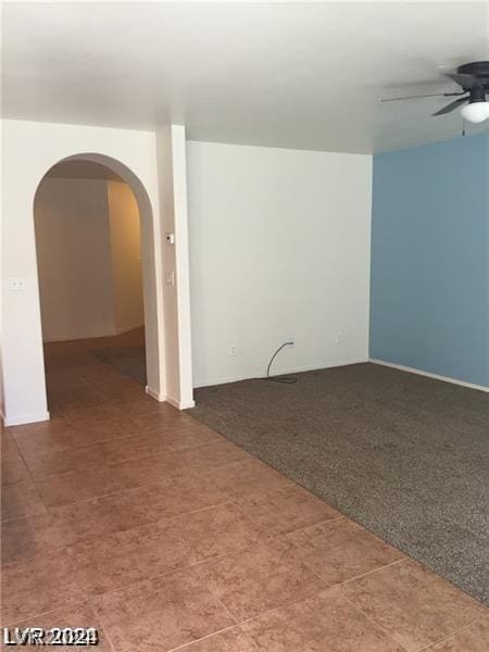 carpeted empty room featuring ceiling fan