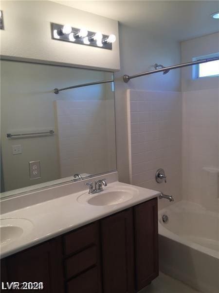 bathroom with shower / bathing tub combination and vanity