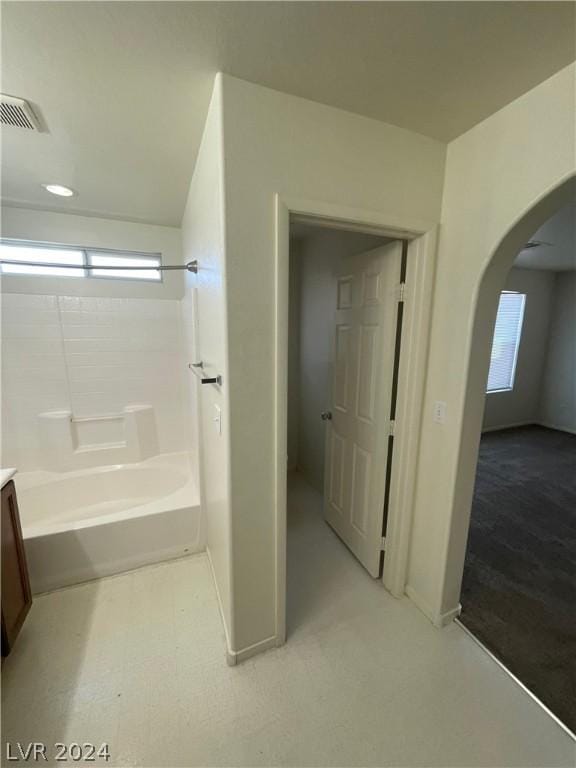 bathroom featuring vanity and  shower combination