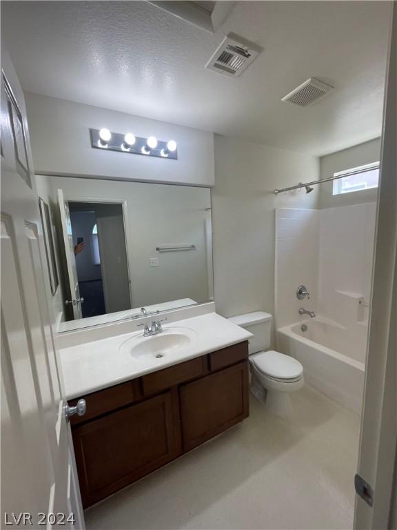 full bathroom featuring toilet, vanity, and bathing tub / shower combination