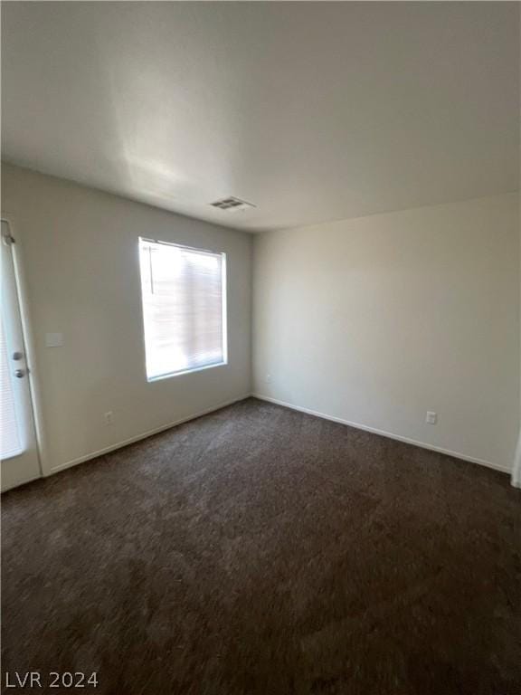 empty room with dark carpet