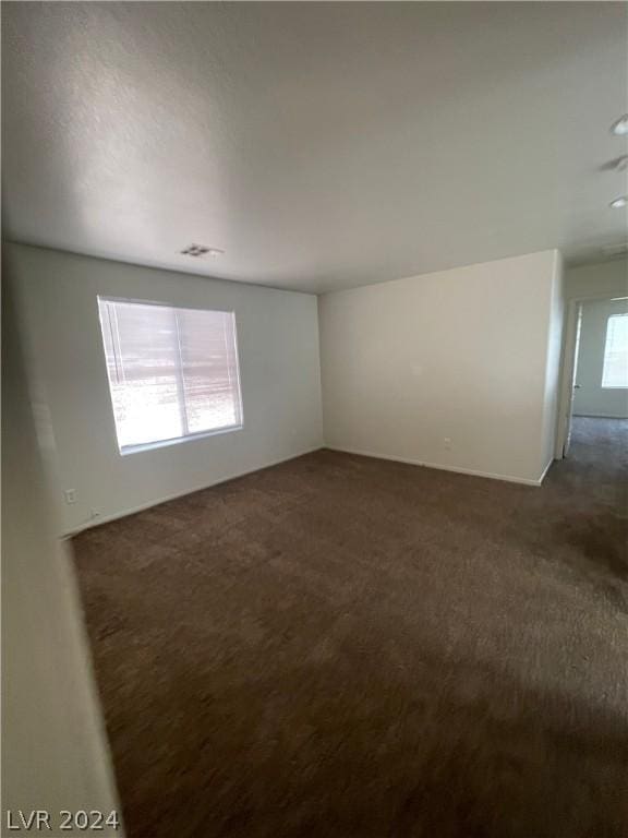 carpeted spare room featuring plenty of natural light