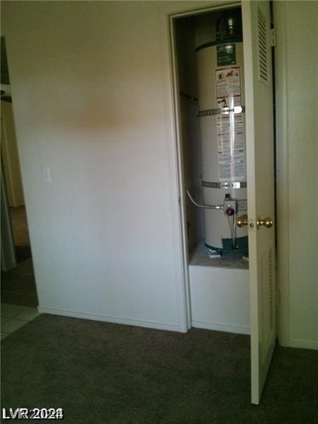 utility room featuring strapped water heater