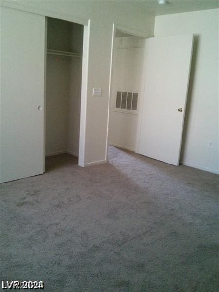 unfurnished bedroom featuring carpet floors and a closet