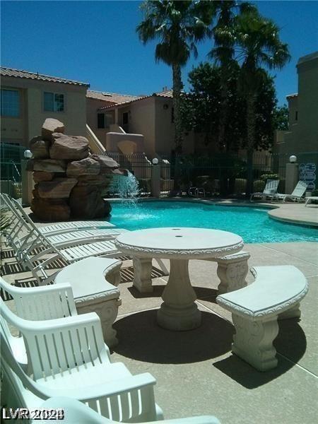 view of swimming pool with a patio and pool water feature