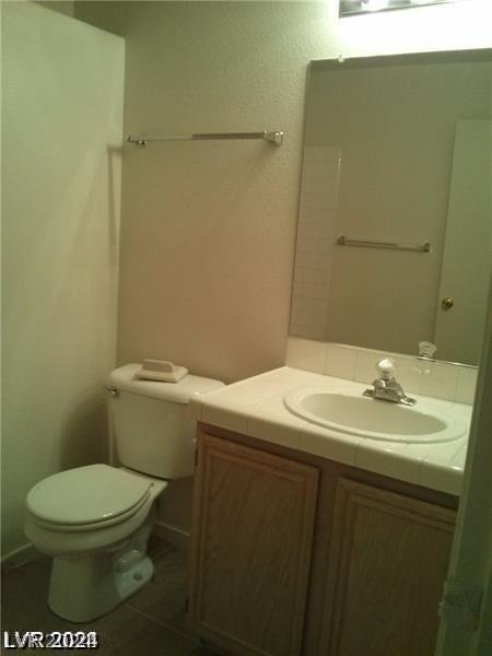 bathroom with vanity, tile patterned floors, and toilet