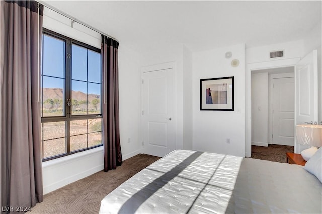 29 Montelago Blvd Unit 201, Henderson, NV 89011 - bedroom featuring a mountain view, dark carpet, and multiple windows