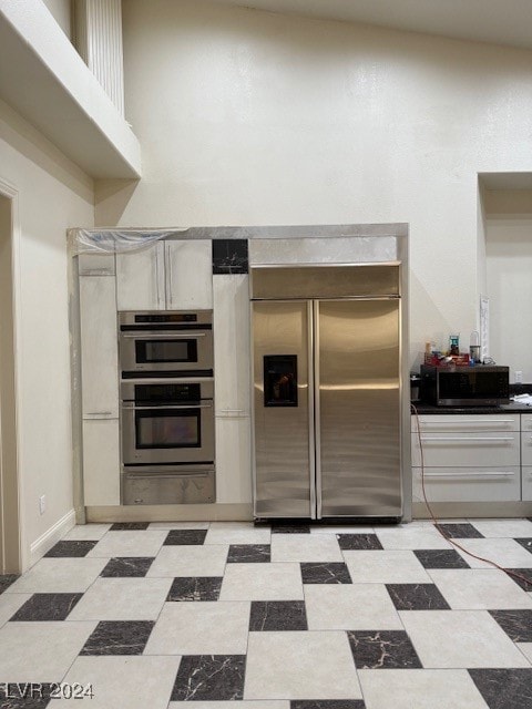 kitchen featuring appliances with stainless steel finishes and vaulted ceiling