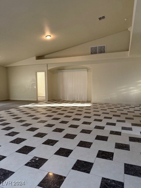 empty room with lofted ceiling