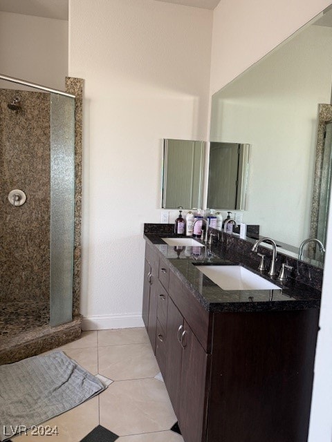 bathroom featuring tile patterned flooring, walk in shower, and vanity