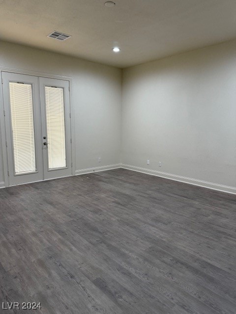 unfurnished room featuring french doors and dark hardwood / wood-style floors