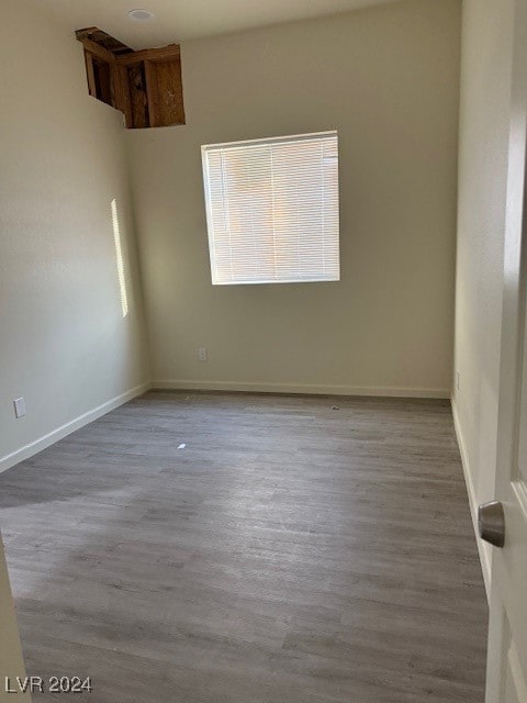 unfurnished room with wood-type flooring