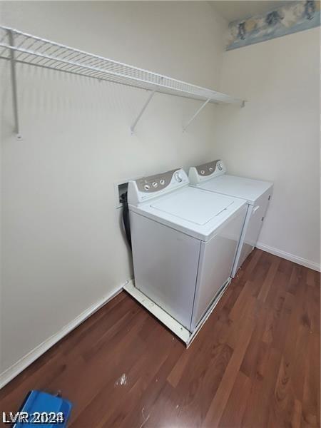 laundry area featuring washer and clothes dryer and dark hardwood / wood-style flooring