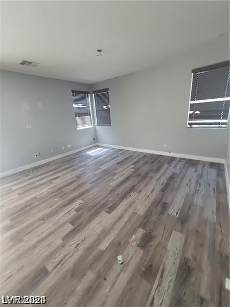 spare room with wood-type flooring