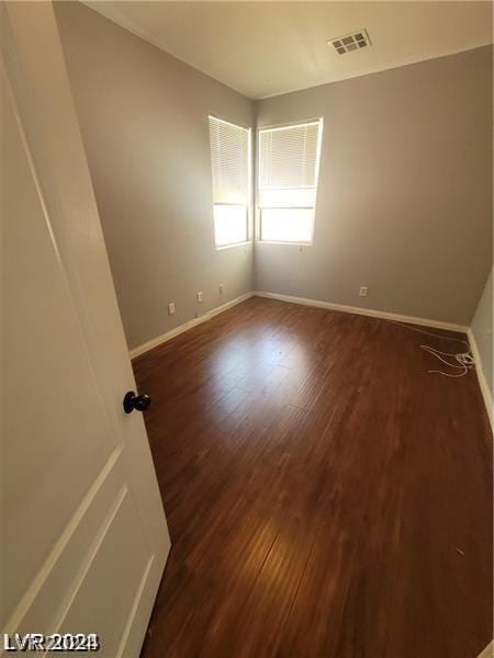 empty room with dark hardwood / wood-style floors