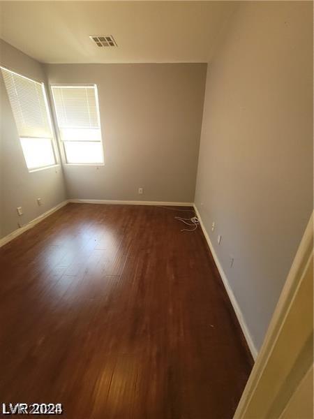 spare room featuring dark wood-type flooring