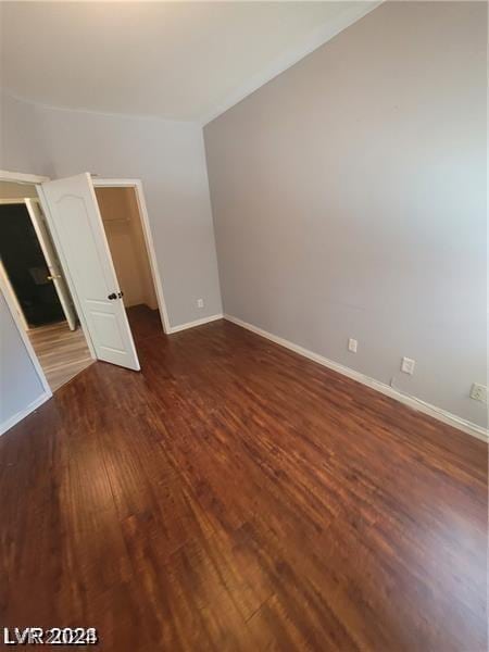 spare room featuring dark wood-type flooring