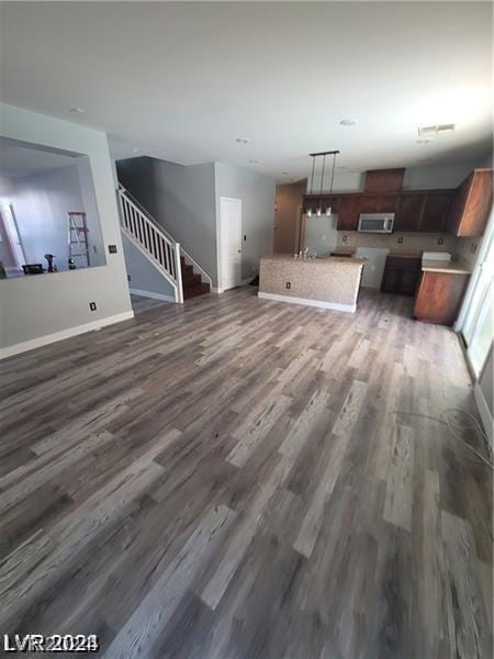 unfurnished living room with dark hardwood / wood-style flooring