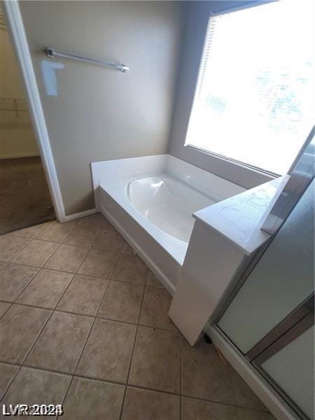 bathroom featuring tile patterned flooring and independent shower and bath