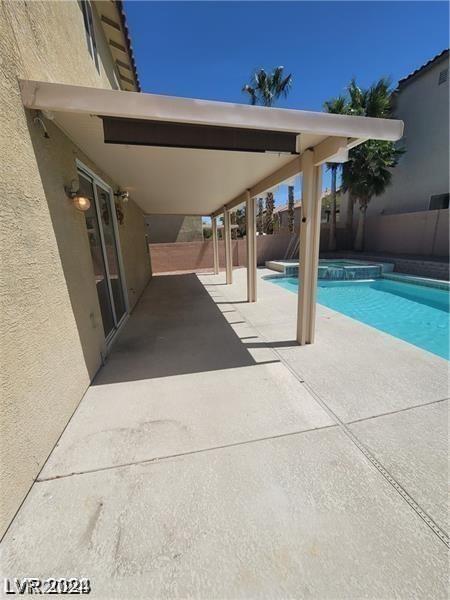 view of swimming pool with a patio area