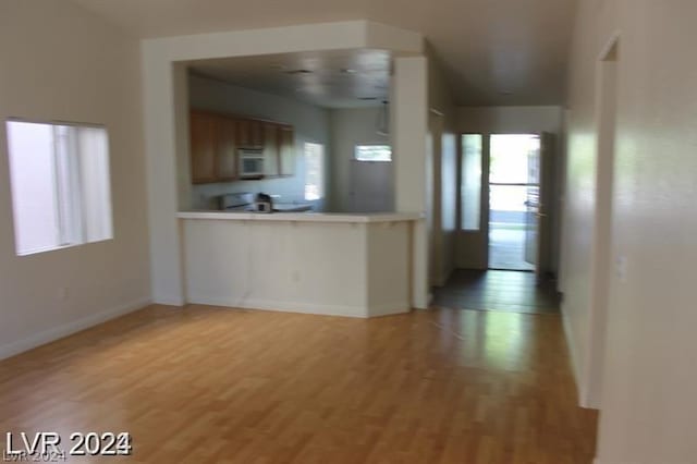 kitchen with range and light wood-type flooring