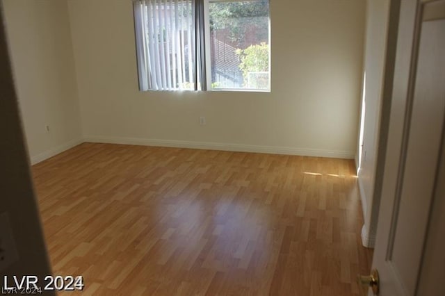 unfurnished room with light wood-type flooring