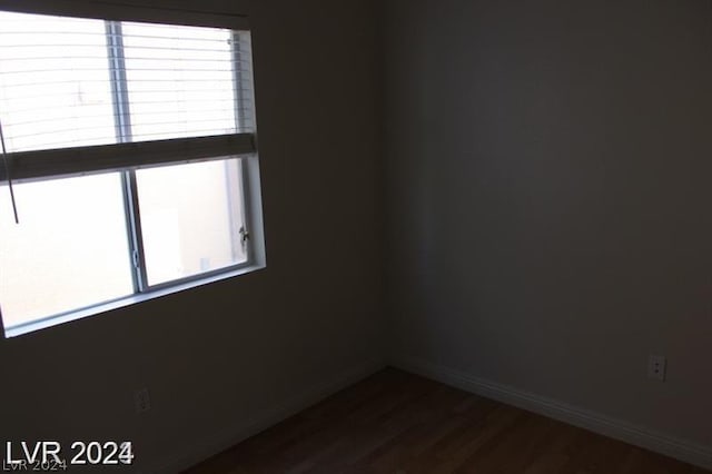 unfurnished room featuring dark wood-type flooring