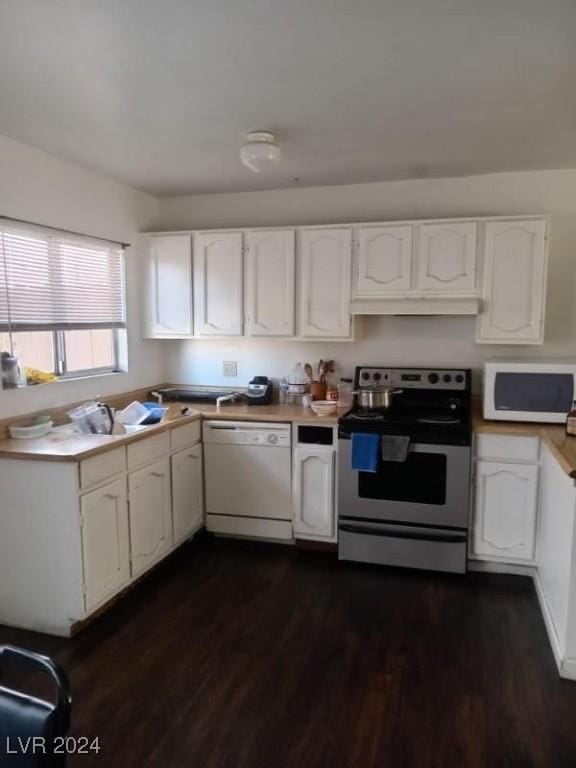 kitchen with white cabinets, white appliances, dark wood-style floors, and light countertops