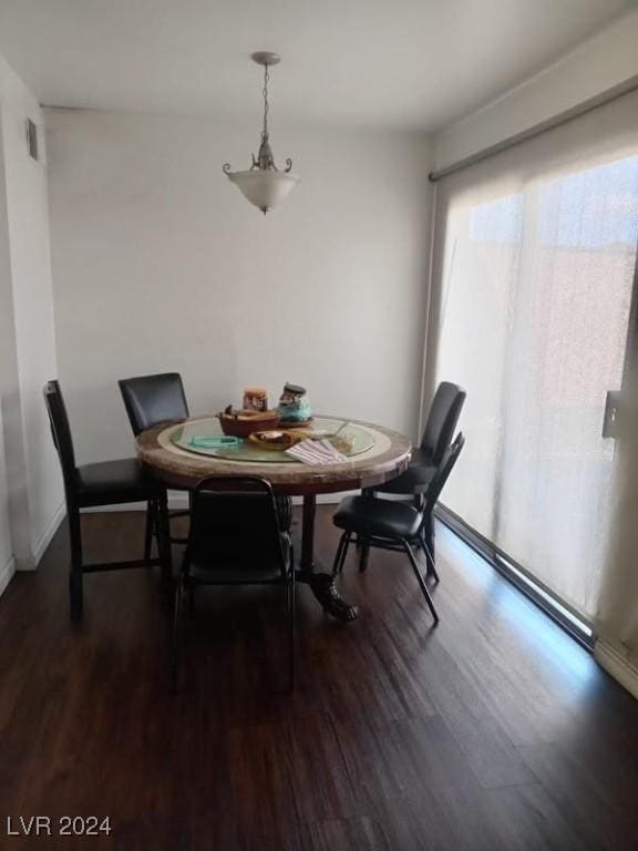 dining area with baseboards and dark wood-style floors