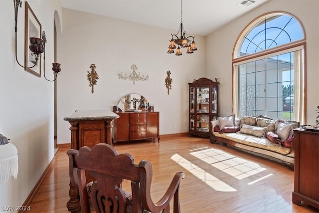 sitting room featuring a chandelier and light wood-type flooring