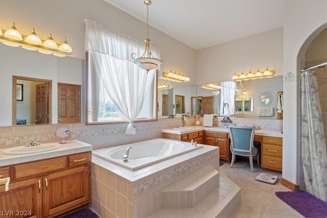 bathroom featuring tile patterned flooring, vanity, decorative backsplash, and shower with separate bathtub