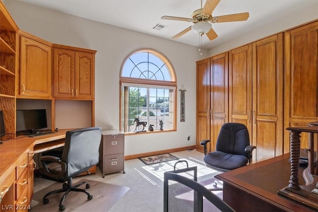 carpeted office with ceiling fan