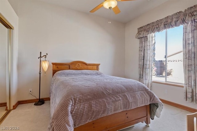 bedroom with light colored carpet, a closet, and ceiling fan