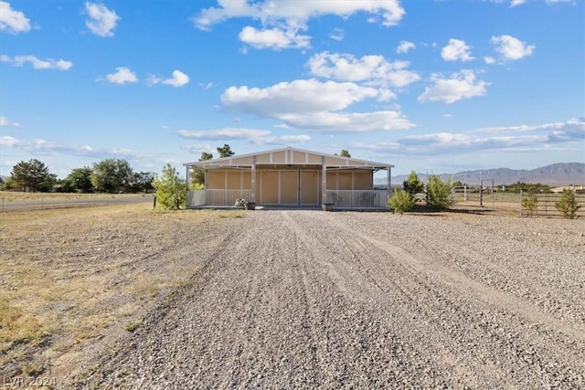 view of outdoor structure featuring a mountain view and a rural view