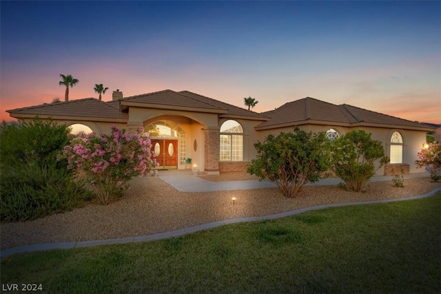 mediterranean / spanish-style house featuring a yard