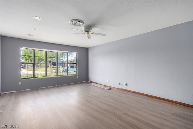 spare room with ceiling fan and hardwood / wood-style floors