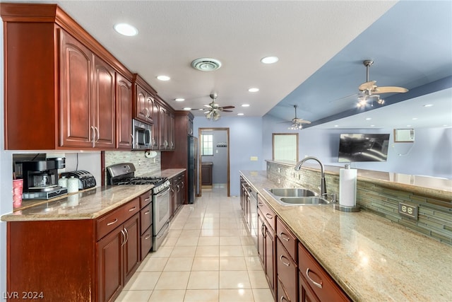 kitchen with stainless steel appliances, ceiling fan, tasteful backsplash, sink, and light tile floors