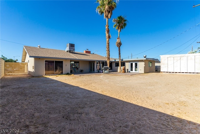 back of property with a patio area and central air condition unit