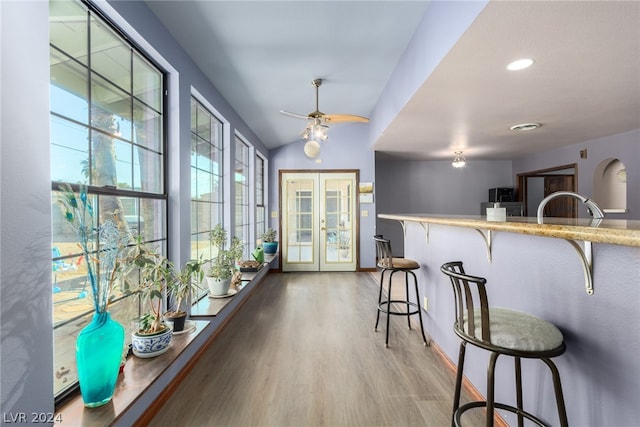 interior space featuring sink, french doors, ceiling fan, and light hardwood / wood-style flooring