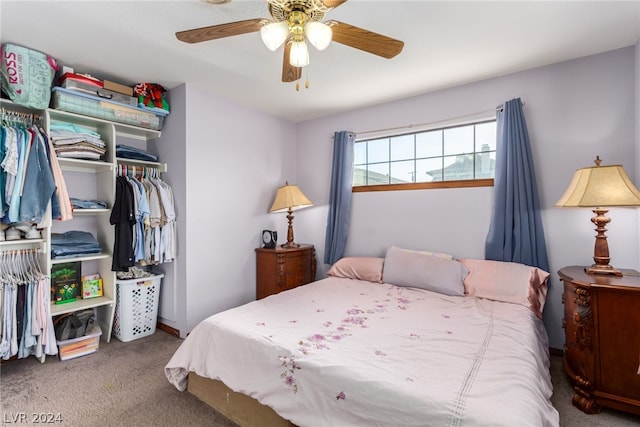 carpeted bedroom with ceiling fan and a closet